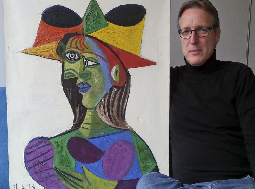 Dutch art detective Arthur Brand is pictured with 'Buste de Femme', a Picasso painting he says he has recovered, 20 years after it was stolen.