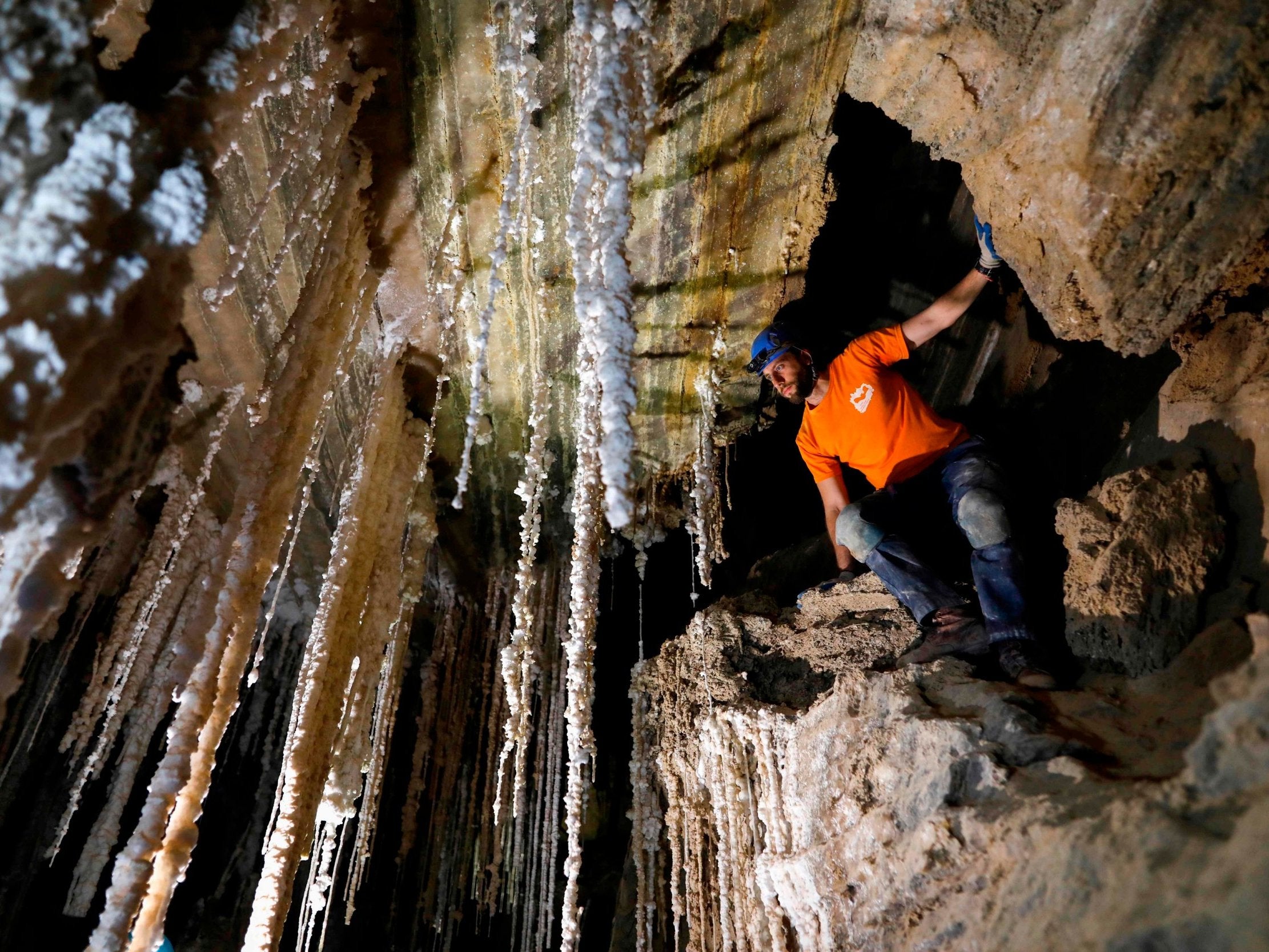 Efraim Cohen of the Israel Cave Explorers Club stands next to salt stalactites in the Malham cave inside Mount Sodom