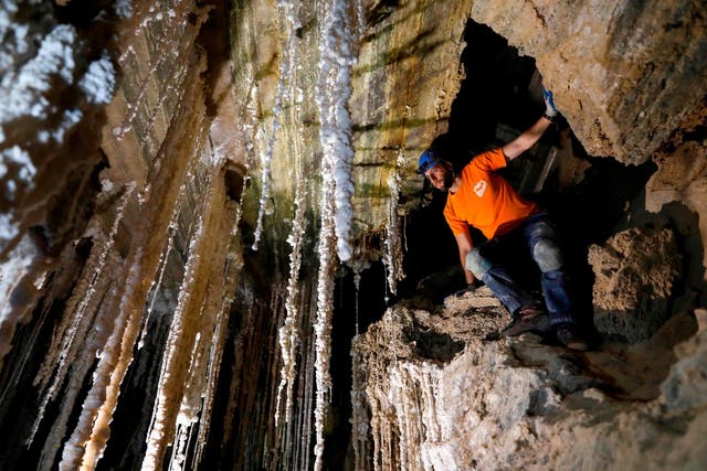 Efraim Cohen of the Israel Cave Explorers Club stands next to salt stalactites in the Malham cave inside Mount Sodom