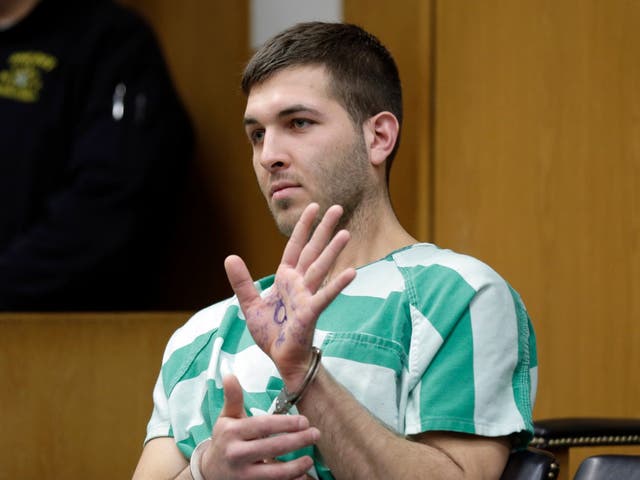 Anthony Comello displays writing on his hand that includes pro-Donald Trump slogans