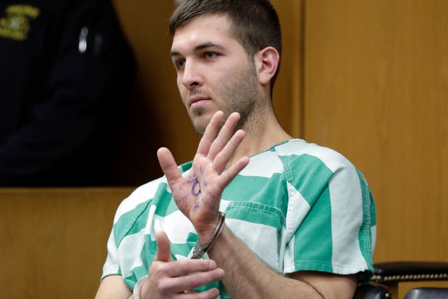 Anthony Comello displays writing on his hand that includes pro-Donald Trump slogans