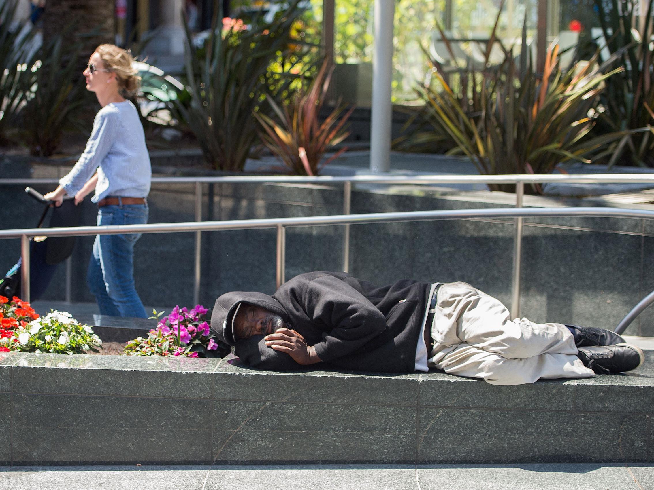 A homeless man sleeps in San Francisco, where more than 7,000 people have nowhere to live