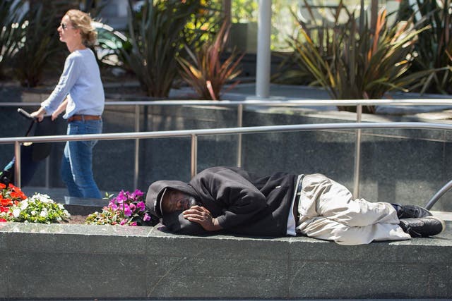 A man sleeps in San Francisco, where more than 7,000 people have nowhere to live