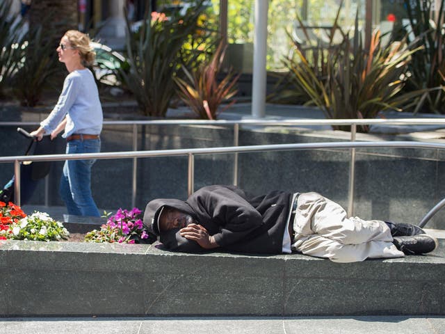 <p>A homeless man sleeps in San Francisco, where more than 7,000 people have nowhere to live</p>