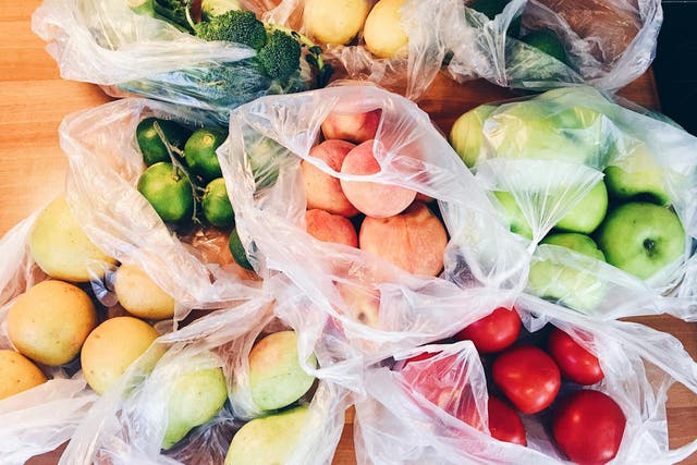 Apples, peachs, tomatoes, pears, cucumbers, avocado packed in plastic bags after shopping