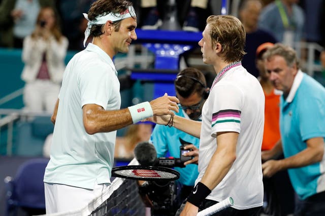 Denis Shapovalov, right, shakes hands with Roger Federer