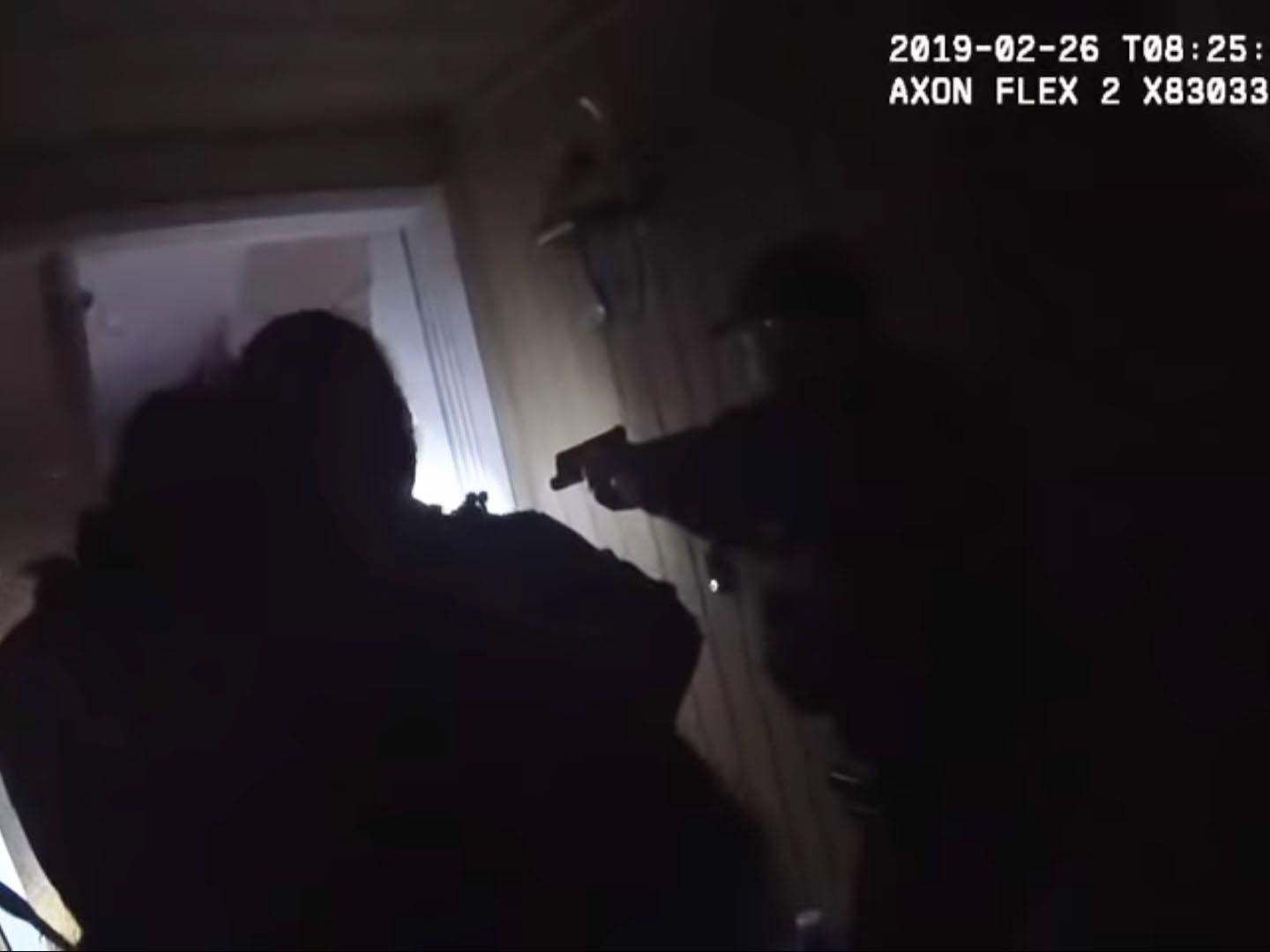 Police officers break down the door of a family home to get to an vaccinated 2-year-old boy with a high fever