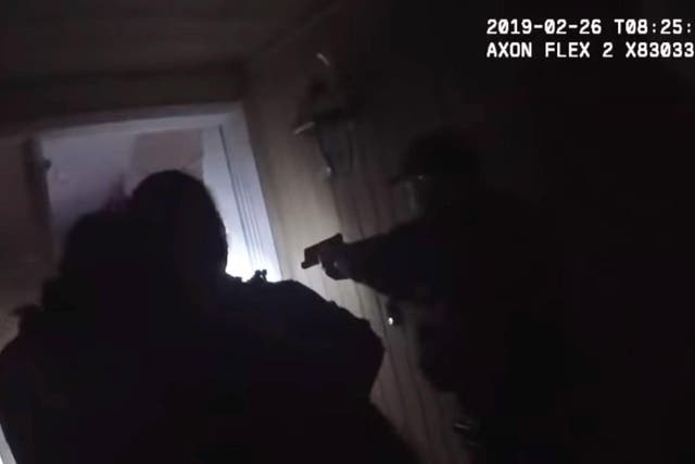 Police officers break down the door of a family home to get to an vaccinated 2-year-old boy with a high fever