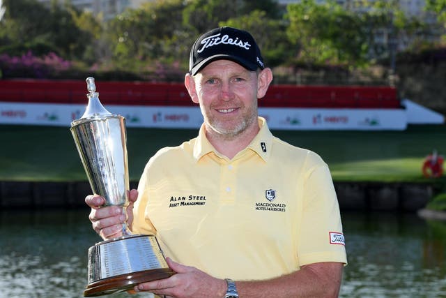Stephen Gallacher holds the trophy in New Delhi