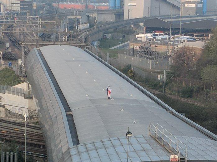 Man with flag spotted on St Pancras roof