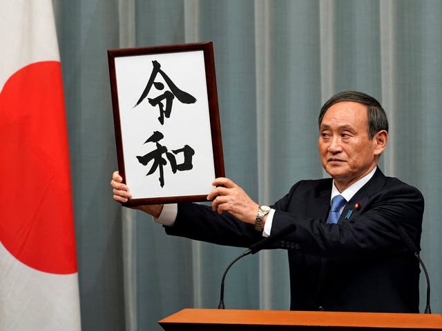 Japan's Chief Cabinet Secretary Yoshihide Suga unveils 'Reiwa' as the new era name at the prime minister's office in Tokyo