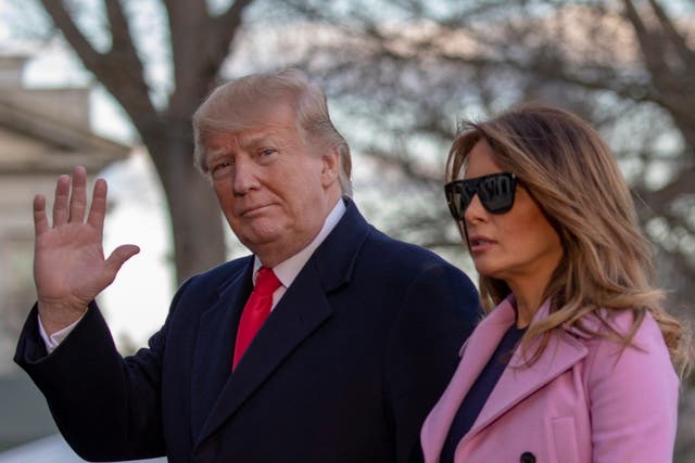 US president Donald Trump and first lady Melania Trump walk off Marine One on the South Lawn of the White House in Washington, DC
