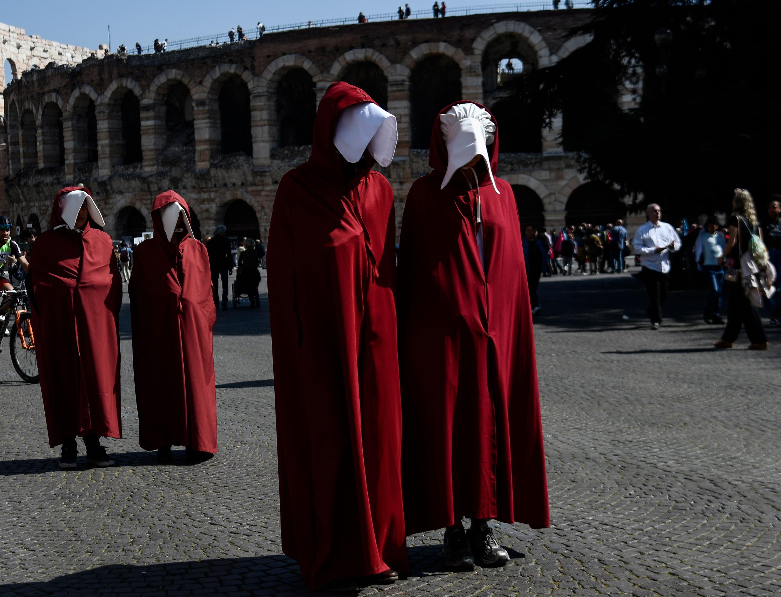 Activists dressed as handmaids outside the US-founded World Congress of Families staged a three-day conference in the ordinarily quiet northern Italian city to discuss 'the beauty of marriage'