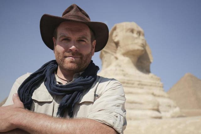 Host Josh Gates posing in front of the Great Sphinx of Giza in Egypt