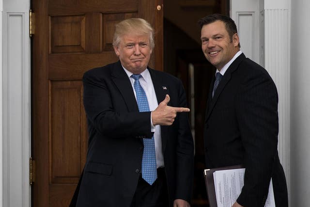 President-elect Donald Trump and Kris Kobach, Kansas secretary of state, pose for a photo following their meeting with president-elect at Trump International Golf Club, November 20, 2016 in Bedminster Township, New Jersey.