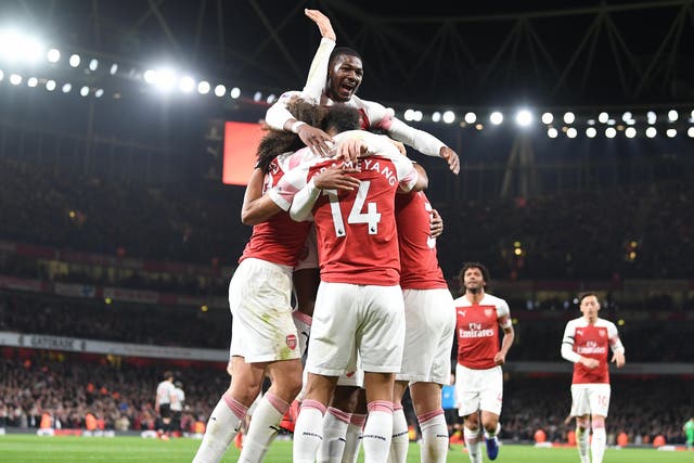 Ainsley Maitland-Niles celebrates as Arsenal score a goal