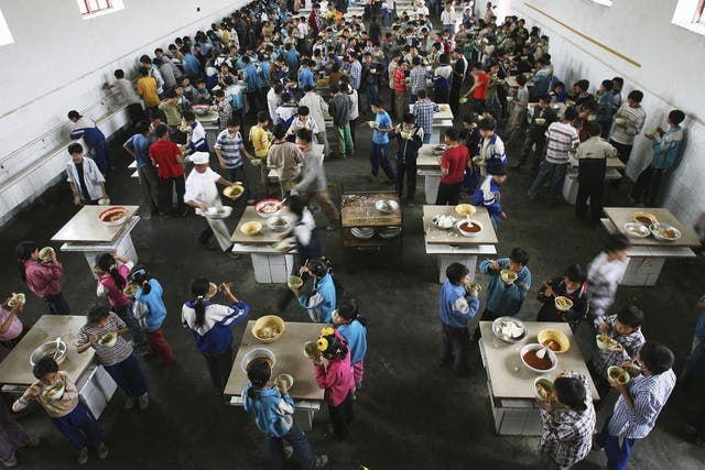 Students eat lunch in a dining hall in Chongqing Municipality, 2006