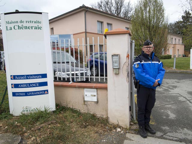 A gendarme stands at the entrance of La Cheneraie where the suspected case of mass food poisoning took place