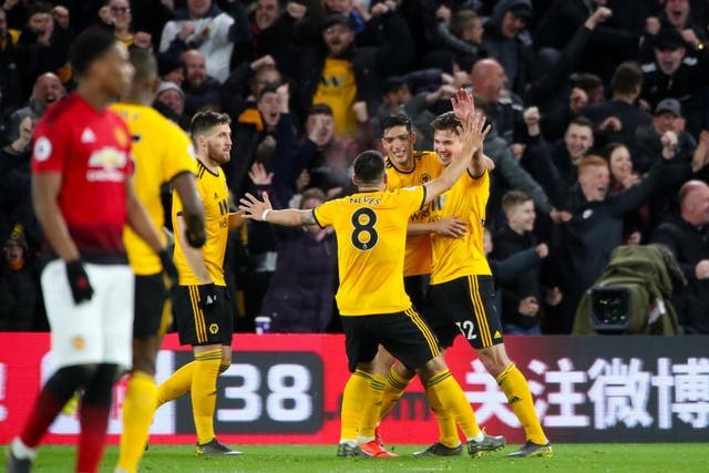 Wolves celebrate after Chris Smalling's own goal