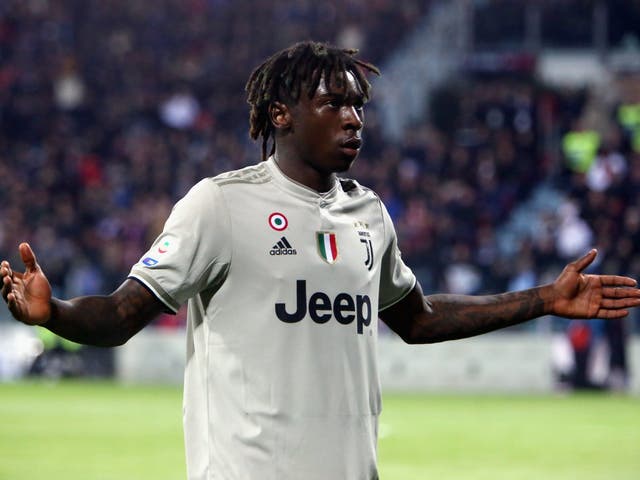 Moise Kean stands in front of Cagliari fans after scoring a late goal