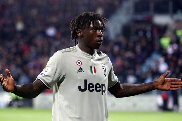 Moise Kean stands in front of Cagliari fans after scoring a late goal