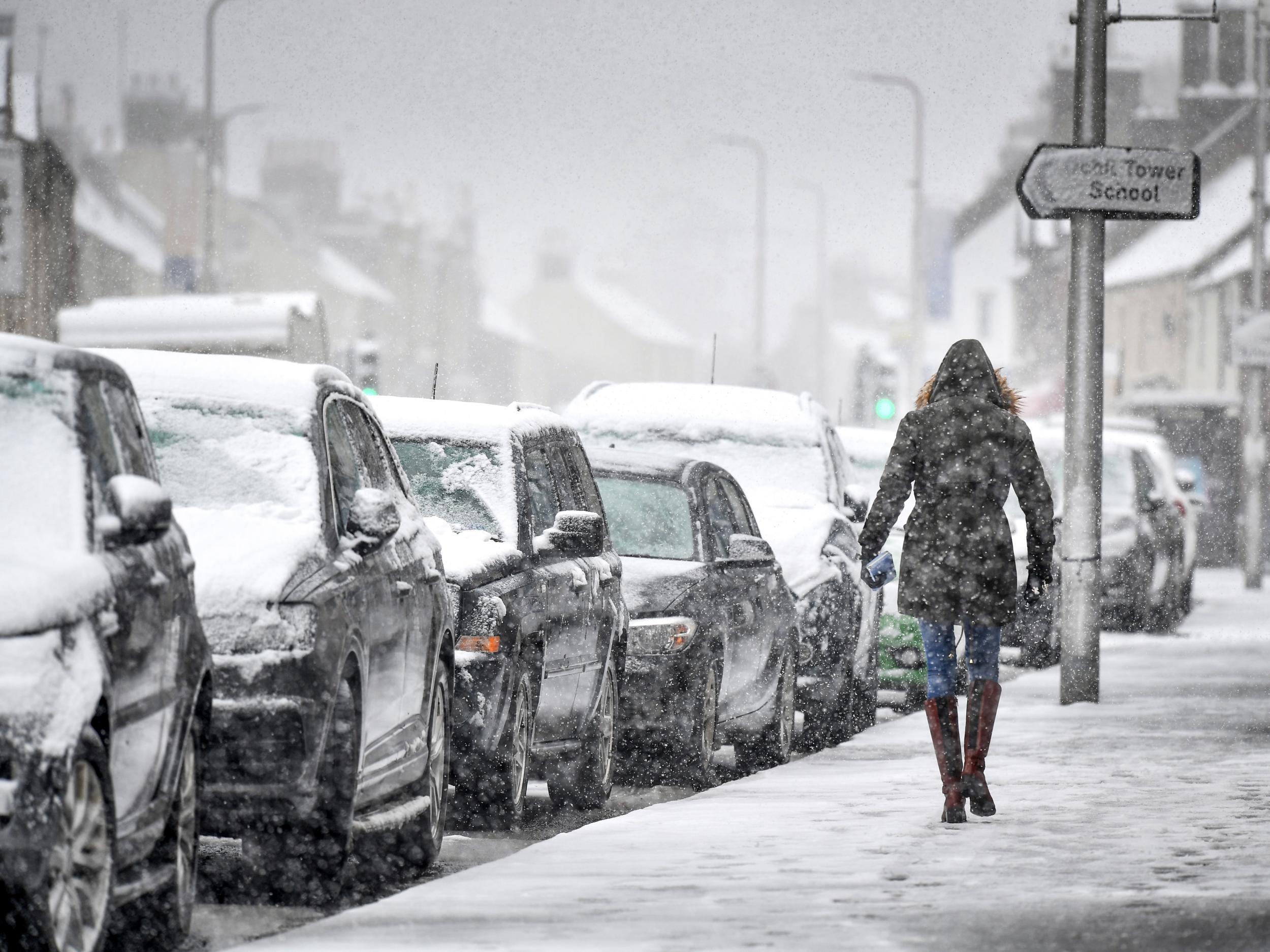 Members of the public walk through the snow on March 16, 2013 in Aucterarder, Scotland