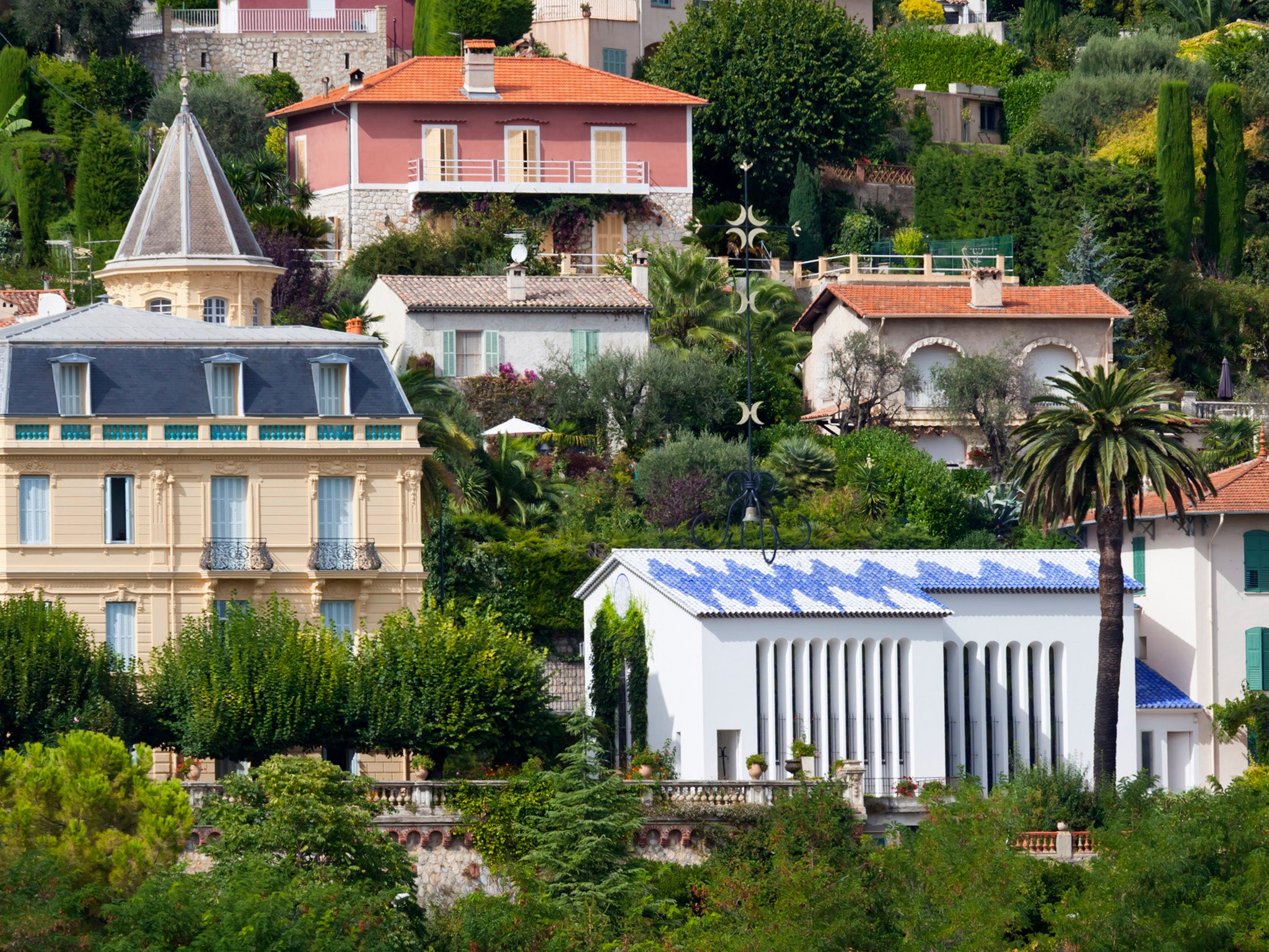 The blue and white Chapel of The Rosary is pictured in the lower right corner. Henri Matisse designed the chapel between 1948 and 1951