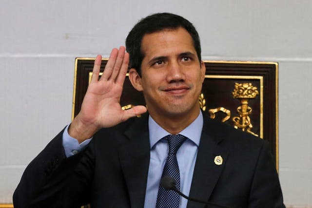Juan Guaido waves to the gallery during a session of the National Assembly in Caracas, Venezuela