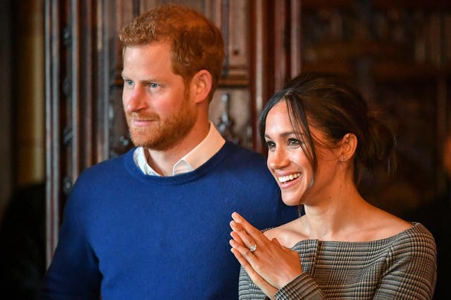 Prince Harry and Meghan Markle watch a performance by a Welsh choir in the banqueting hall during a visit to Cardiff Castle on 18 January 2018