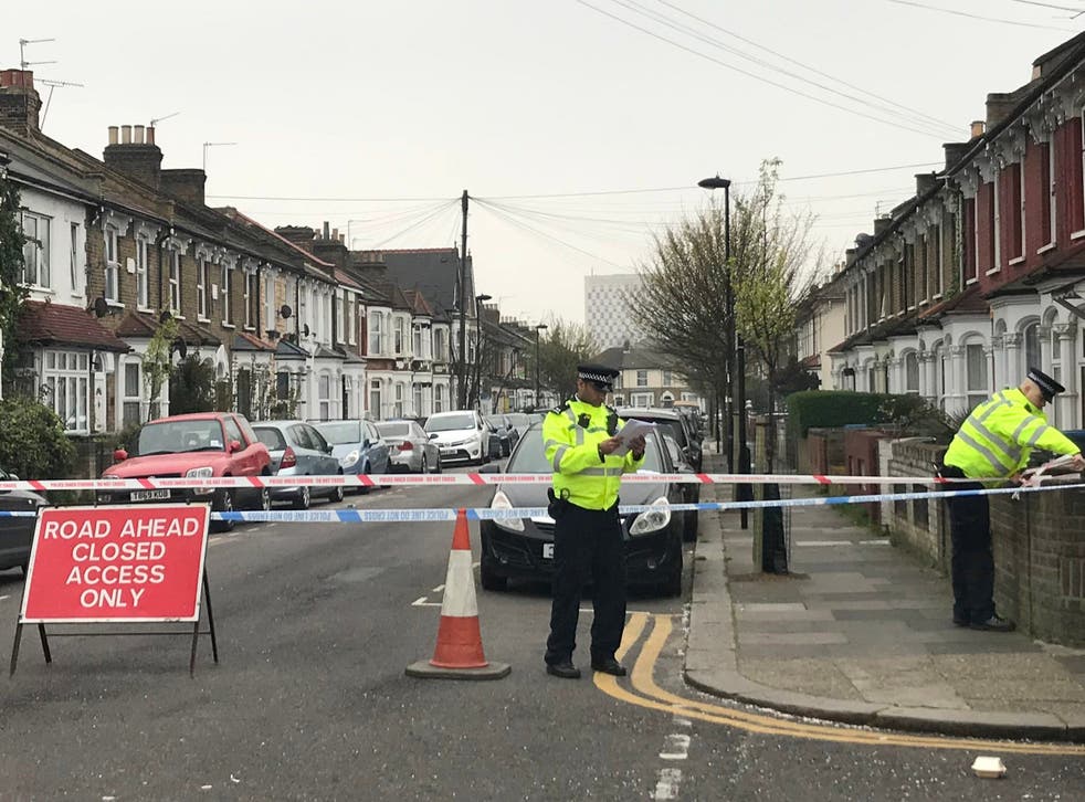 Police officers on Fairfield Road, Enfield, where a man suffered life-threatening injuries after being stabbed.