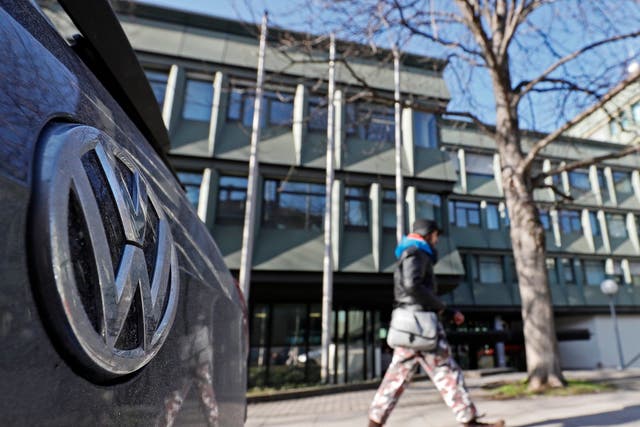 A VW (Volkswagen) logo on a car seen in front of the Higher Regional Court (OLG) in Stuttgart