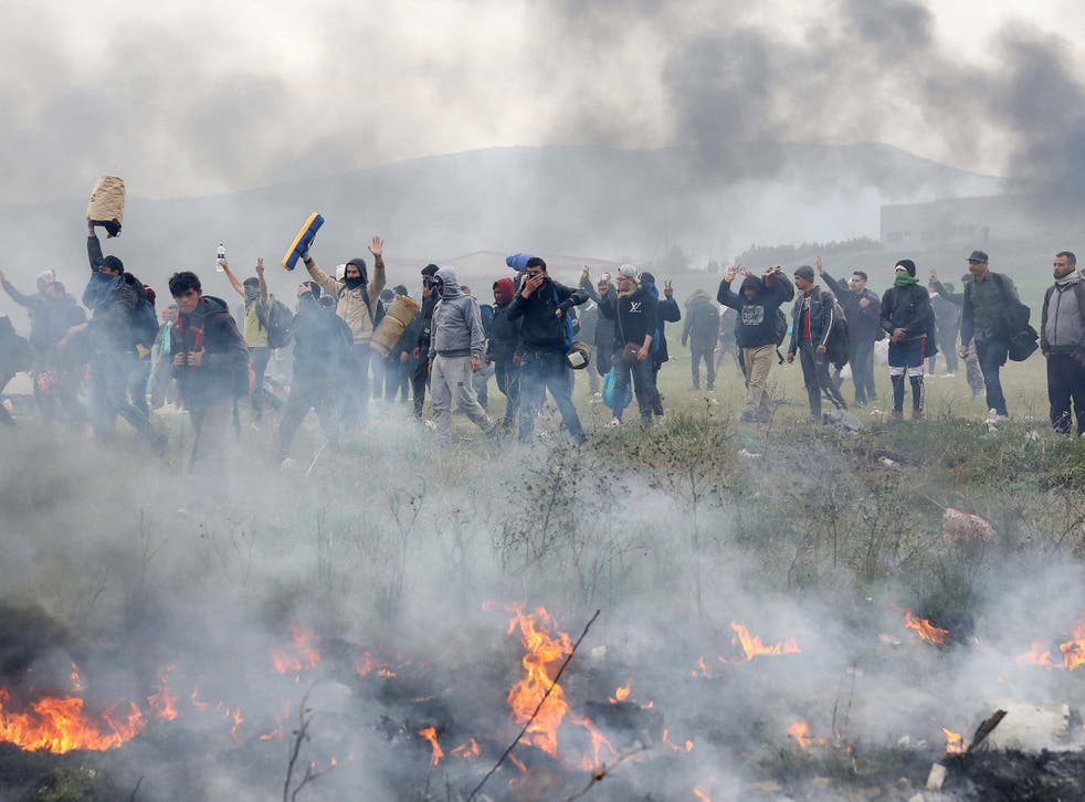 Refugees protest near a refugee camp in the village of Diavata, west of Thessaloniki