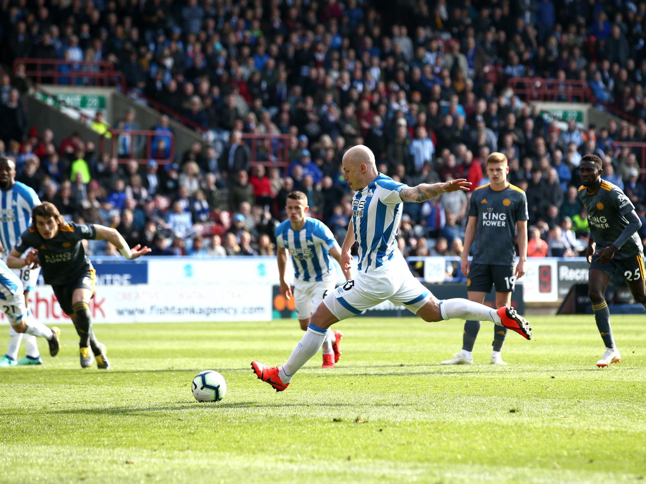 Aaron Mooy converts from the spot to pull one back for Huddersfield