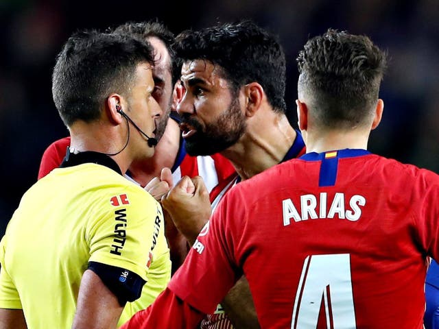 Diego Costa confronts the referee after his red card