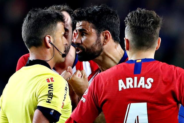 Diego Costa confronts the referee after his red card