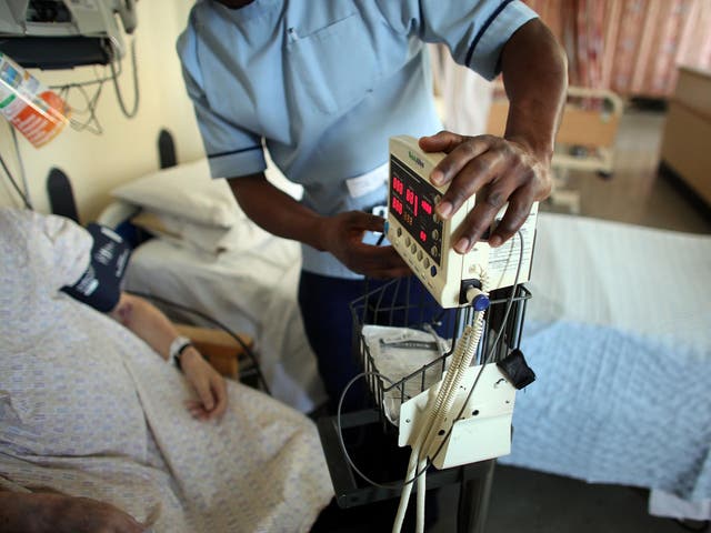 A nurse tends to recovering patients on a general ward at The Queen Elizabeth Hospital on March 16, 2010 in Birmingham