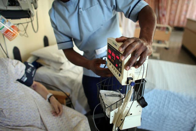A nurse tends to recovering patients on a general ward at The Queen Elizabeth Hospital on March 16, 2010 in Birmingham