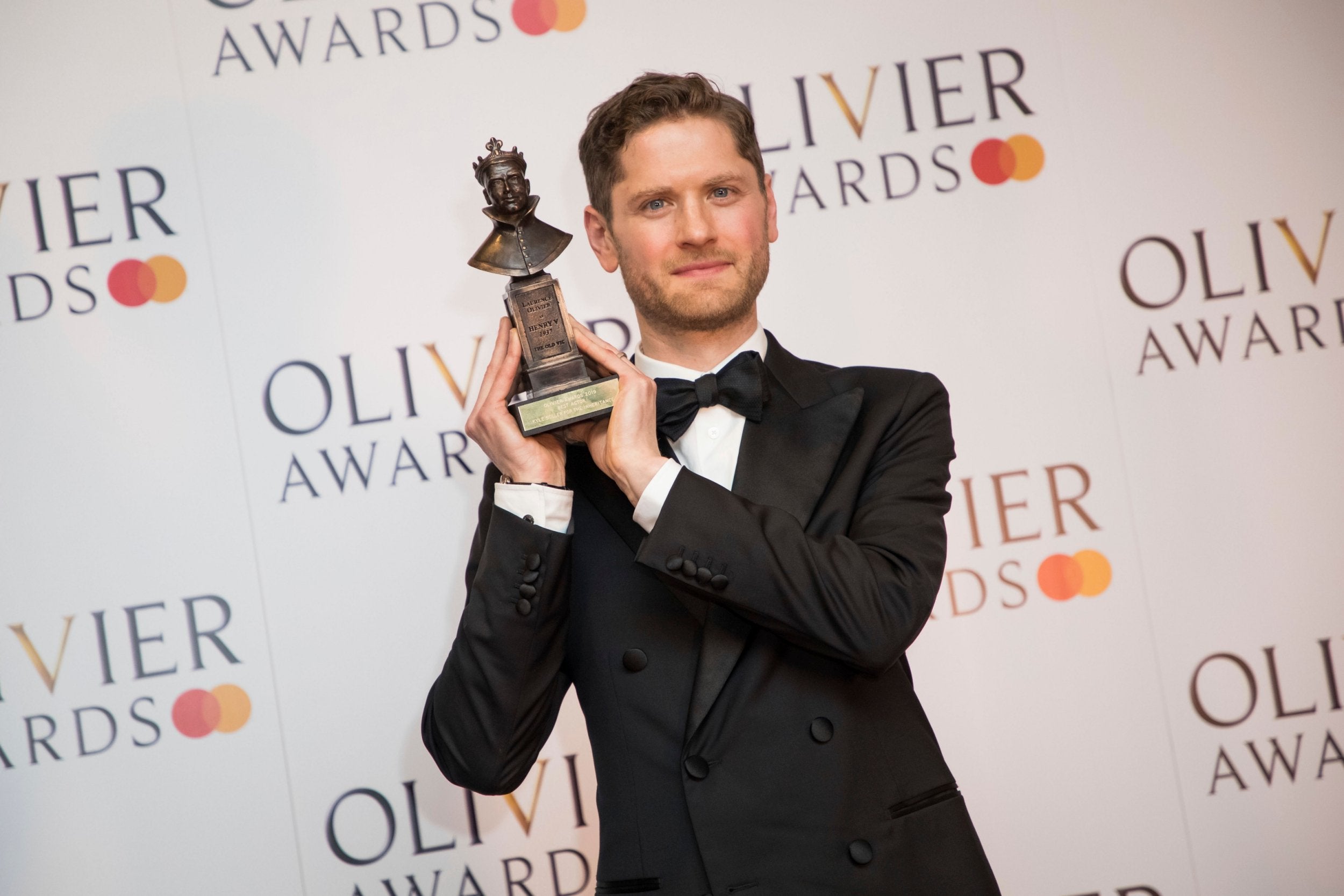 Kyle Soller poses backstage at the Olivier Awards with his trophy for Best Actor