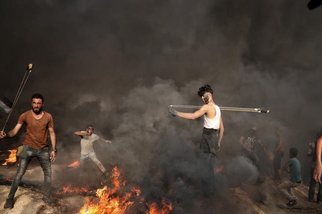 Mohammed Bourdaini, 18, protests at the Israel-Gaza border in October 2018. He was hit in the leg by a bullet last month.