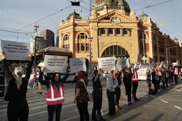 Vegan and animal rights protesters block the road in Melbourne, Australia