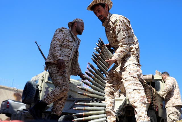 A Member of Misrata forces, under the protection of Tripoli's forces, prepares himself to go to the front line in Tripoli