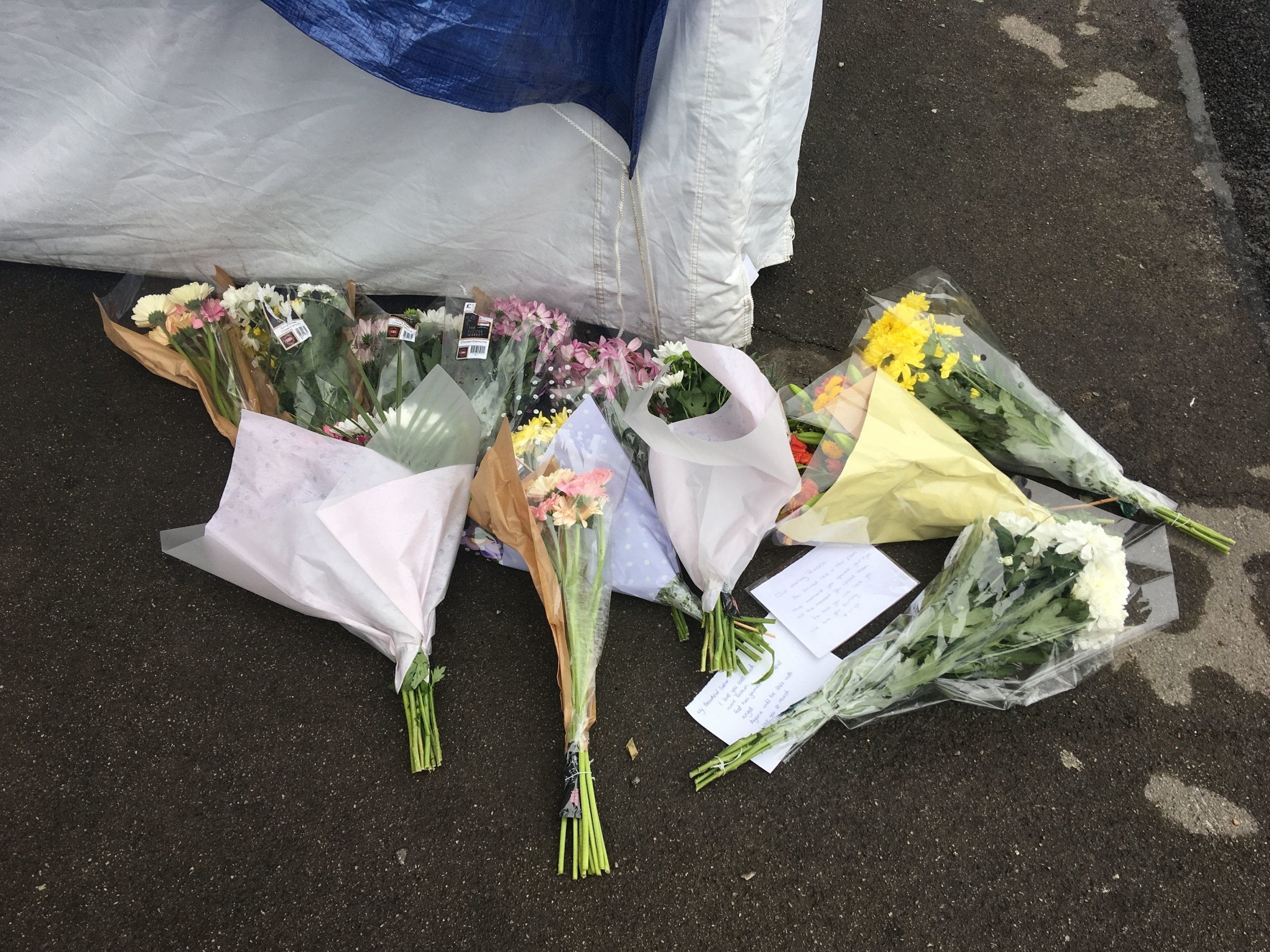 Tributes left outside the entrance to a block of flats in Brookbank, Turkey Street, Enfield, north London, where a woman died on 7 April 2019.