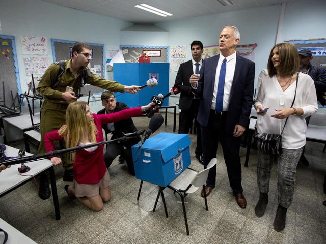 Blue and White party leader Benny Gantz, right, casts his vote with his wife Revital Gantz left, and former Israeli Chief of Staff Benny Gantz during Israel's parliamentary elections in Rosh Haayin, Israel, Tuesday 9 April 2019.