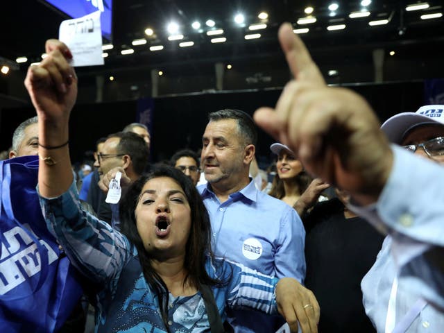 Supporters of Israeli Prime Minister Benjamin Netanyahu's Likud party react to exit polls, some of which have given him victory.