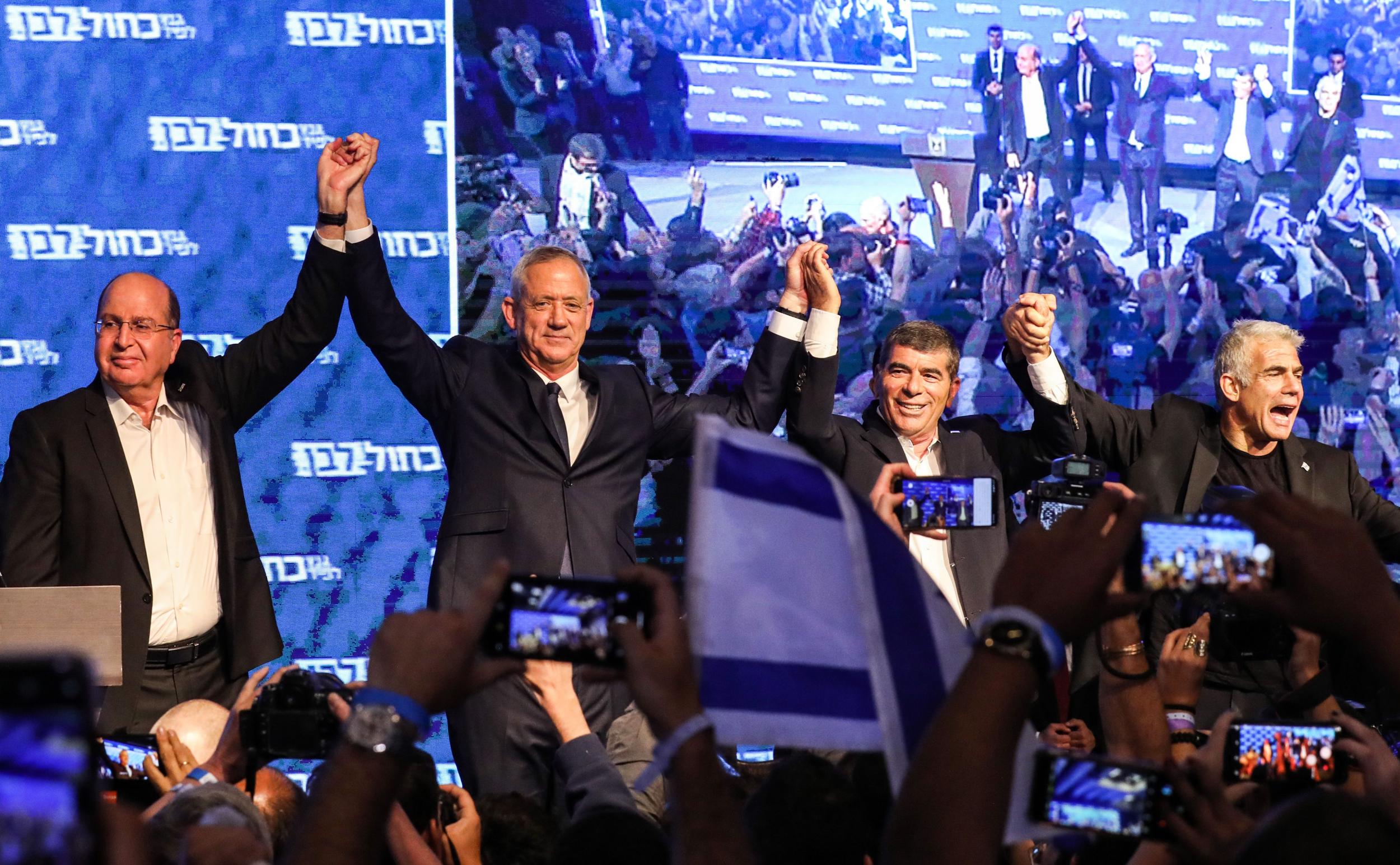 Moshe Yaalon, Benny Gantz, Gabi Ashkenazi, and Yair Lapid of the Blue and White party, appear before supporters at the alliance headquarters in Tel Aviv