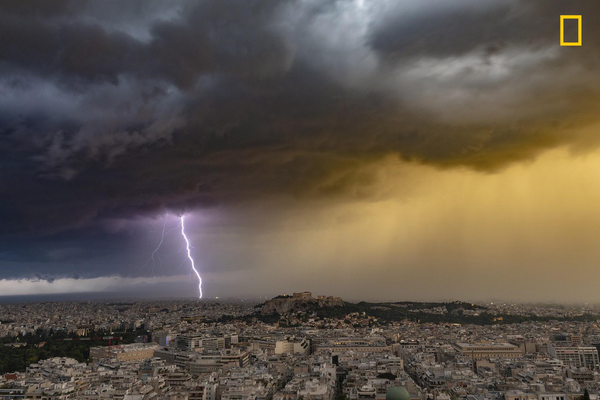 Lightning strikes the shoreline of Attica behind the Acropolis of Athens, Greece during a severe summer thunderstorm on June 23, 2018