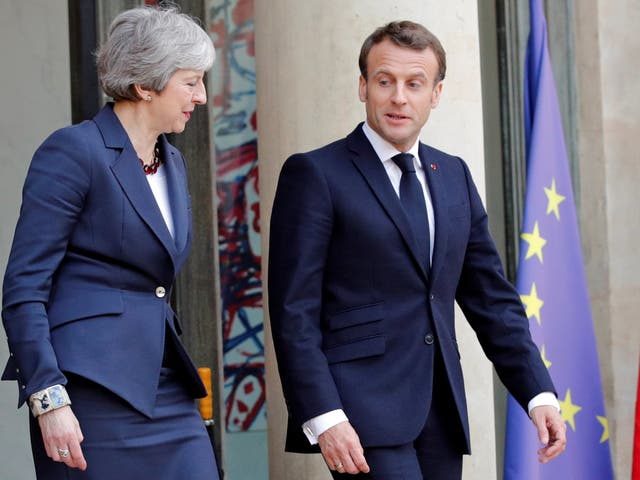 Emmanuel Macron and Theresa May leave after a meeting to discuss Brexit at the Elysee Palace in Paris on Tuesday