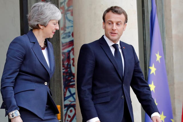 Emmanuel Macron and Theresa May leave after a meeting to discuss Brexit at the Elysee Palace in Paris on Tuesday
