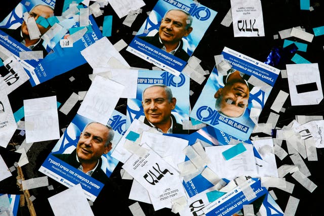 Likud posters featuring Benjamin Netanyahu are strewn on the floor yesterday morning