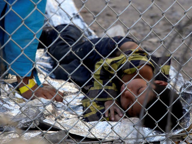 Central American migrants are seen inside an enclosure where they are being held by US Customs and Border Protection (CBP), after crossing the border between Mexico and the United States illegally and turning themselves in to request asylum, in El Paso, Texas, 28 March 2019.